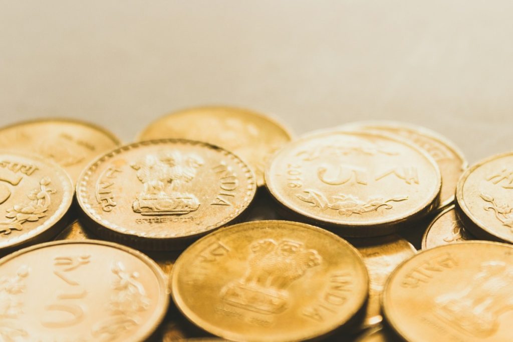 Gold coins spread out on table